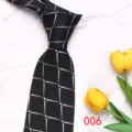 Detail shot of a stylish black men's tie with silver geometric pattern on marble. - Color 006