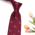 Detail view of burgundy men's retro tie, polyester fabric with small animal pattern. - Color 002