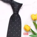 Close-up detail of a classic black men's necktie featuring stylish white polka dot pattern design. - Color 008