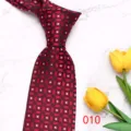Close-up detail view of retro geometric red men tie featuring elegant patterns displayed on marble. - Color 010