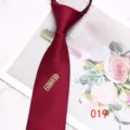 Detail view of a burgundy zipper necktie with metal pendant, showcasing smooth texture and design. - Color 019