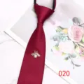 Burgundy zipper tie close-up featuring an elegant gold bee brooch with a pearl body. - Color 020