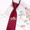 Close-up detail of burgundy zipper necktie with rhinestone love brooch, elegant accessory. - Color 022