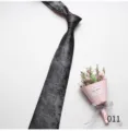 Detailed close-up shot of the elegant black patterned men business casual necktie material. - 011