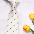 Detailed shot of elegant light-colored men's tie with refined geometric square pattern. - No. 007 - Light Small Checks