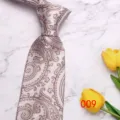 Detail view of a classic light paisley men's tie, elegant business formal necktie. - No. 009 - Silver Gray Paisley