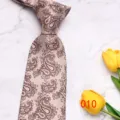 Classic men's 8cm silk tie featuring elegant brown paisley pattern on light background. - No. 010 - Light Brown Paisley