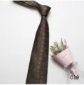 Detail view of a classic green patterned mens necktie for business and formal wear. - Color 019