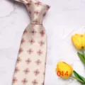 Detail view of the champagne patterned tie, elegant floral print for business and formal wear. - No. 014 - Champagne Four-Leaf Clover