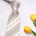 Detail view of men's stripe tie in light color, fine pattern design for business wear. - No. 022 - Light Deep Green Striped