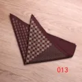 Detail view of a stylish mens burgundy pocket square with geometric and paisley print patterns. - Color 013
