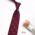 Burgundy woven men's tie with fine animal pattern detail closeup shot on clean background - Color 016