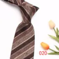 Detailed shot of brown mens paisley patterned business necktie showing fabric and stripe detail. - Brown Paisley Stripe (020)