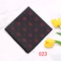 Detail van herenpochet met donkere stof en rood geometrisch patroon op marmer. - Pantserontwerpstijl