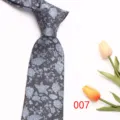 Grey floral necktie detail showcasing fine woven texture and elegant pattern design. - Style 007