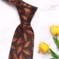 Detailed close-up shot of brown men's business woven silk necktie with vintage pattern texture. - Style D