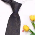 Detail shot of men's business silk necktie in dark blue with golden floral pattern. - Style G
