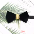 Detailed view of a classy black velvet bow tie with a gold striped center knot for formal suits. - Black