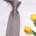 Close-up detail of the classic grey paisley men's tie, showing fine geometric woven texture. - No. 027 - Gray Brown Geometric Paisley