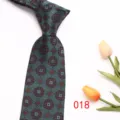Close-up of the elegant patterned silk business tie detail, featuring geometric red motifs. - Style 018