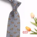Grey herringbone necktie detail showcasing elegant woven gold horse patterns and fabric texture. - Style 023