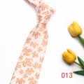 Detail shot of men casual tie featuring elegant orange maple leaf pattern on light fabric. - Color 013