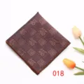 Detailed view of brown checkered pocket square, classic suit accessory for formal menswear. - Color 018