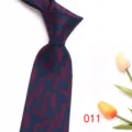 Close-up detail of dark blue men's necktie featuring burgundy feather jacquard pattern. - Dark Blue