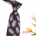 Detailed view of dark purple men's business tie with elegant silver feather jacquard pattern. - Deep purple