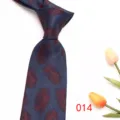 Men's jacquard patterned necktie detailed view showing fine blue fabric texture and red feather print. - Dark Blue