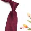 Burgundy red men's business formal jacquard tie detail view showing elegant leaf pattern texture. - Burgundy