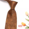 Mens jacquard tie business formal necktie detail view showing stylish leaf pattern. - Brown