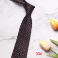 Detailed close-up of dark green men's business tie with retro paisley pattern on marble. - 8cm 006