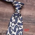 Detailed view of classic paisley patterned silk necktie with elegant blue floral design on white. - Color 007