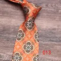 Orange paisley pattern tie detail shot, classic floral necktie accessory for men. - Color 013