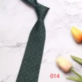 Dark green business necktie detail shot, featuring subtle geometric patterns on smooth fabric. - 8CM014