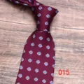 Close-up detail of the burgundy floral pattern necktie fabric and exquisite craftsmanship. - Color 015