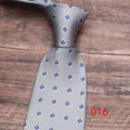 Men's grey floral tie detail shot, elegant business casual necktie with blue flower pattern. - Color 016