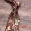 Close-up detail of a dark red floral print necktie with vintage botanical pattern design. - Color 020