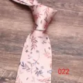 Detail view of pink floral necktie with delicate leaf patterns, fine fabric texture. - Color 022