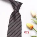 Close-up detail view of mens business striped tie texture, classic diagonal pattern fabric. - Color 022
