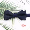 Detail view of a stylish navy blue double layer bow tie with glitter fabric and satin knot. - Color 006