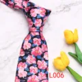Men's fashion printed floral tie detail shot, showing colorful botanical pattern texture close up. - L006