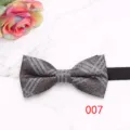Detailed view of a stylish plaid bow tie with textured fabric and classic British pattern. - Color 007