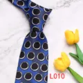 Blue patterned necktie detail showing black and white circular print on silky fabric. - L010