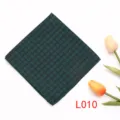 Detalle de pañuelo de bolsillo verde oscuro estampado, accesorio geométrico de traje. - L010