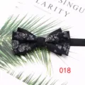 Vista detallada de una pajarita negra de poliéster con motivo floral plateado elegante. - Estilo 018