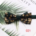 Detailed closeup of a luxurious double-layer men's green and gold leaf pattern bow tie. - Color 021