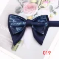Detail view of dark blue layered floral bow tie showing exquisite texture and elegant style. - Color 019