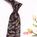 Close up of purple mens business jacquard tie with elegant gold feather pattern detail. - Deep purple